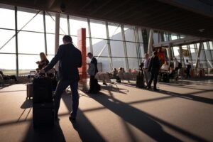 Well dressed passengers waiting to board at boarding gate